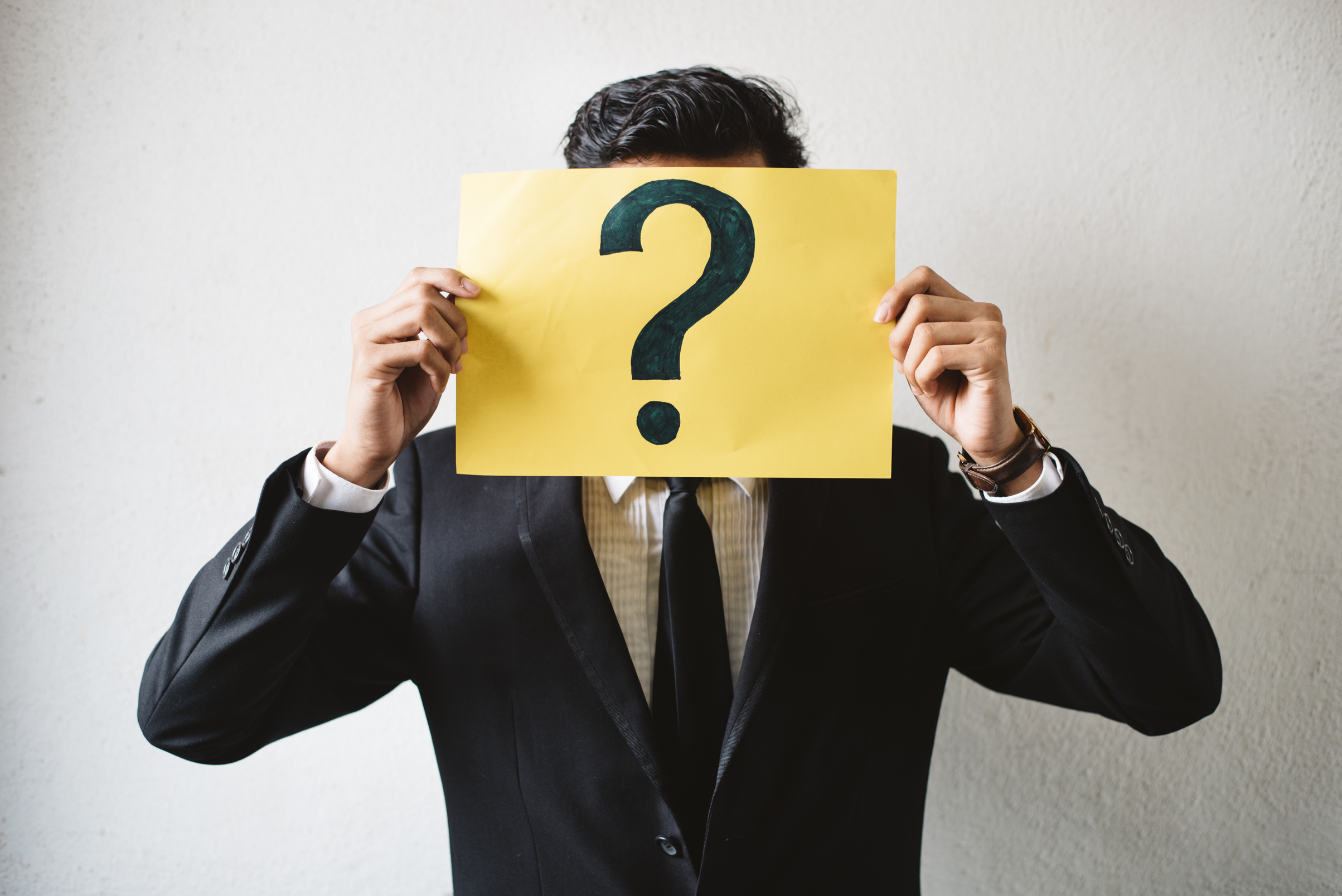 Businessperson Holding Paper With Question Mark